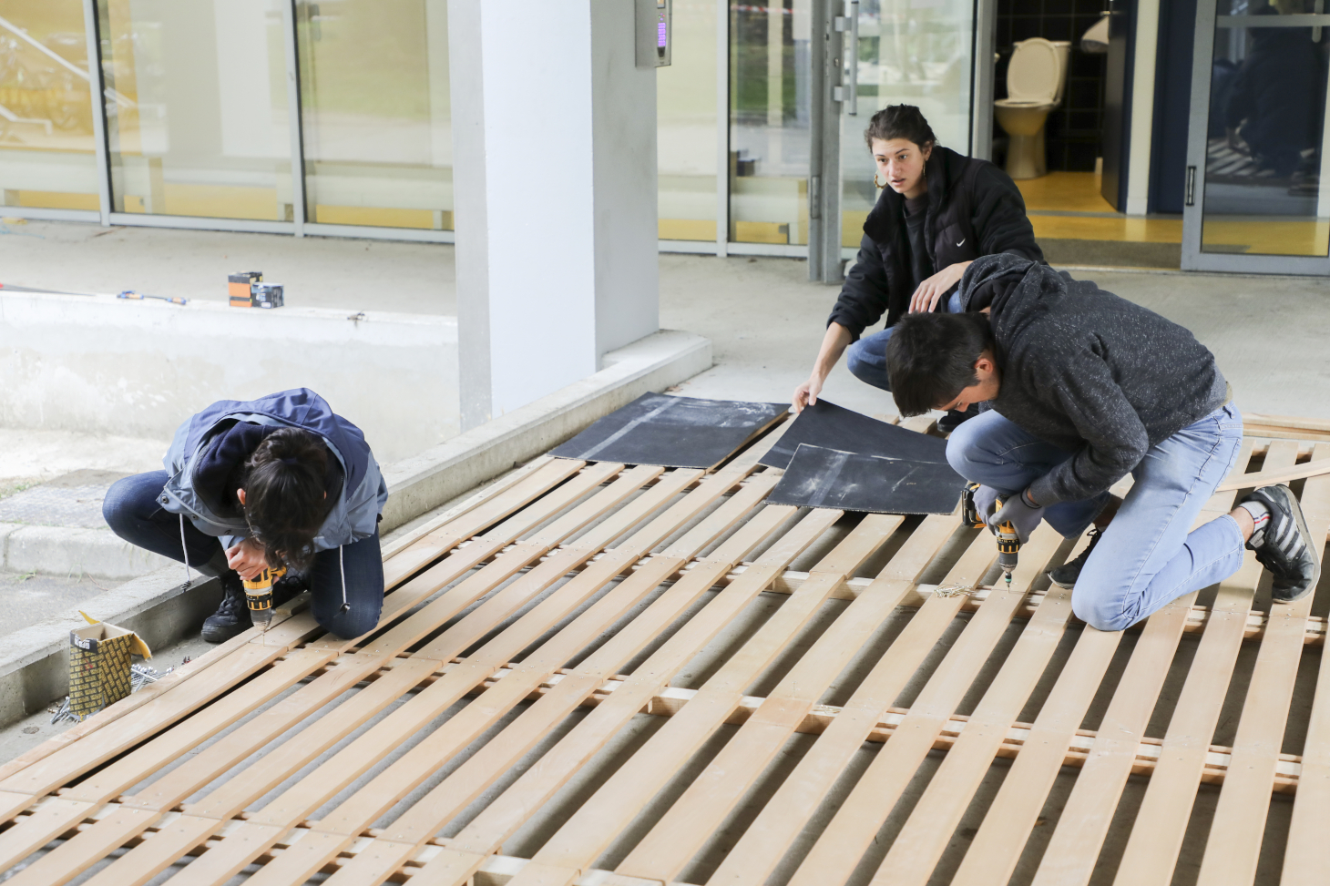 Les étudiantes et étudiants en action sur le chantier de construction en matériaux de réemploi devant le bâtiment Bergès sur le domaine universitaire. Les étudiantes et étudiants en action sur le chantier de construction en matériaux de réemploi devant le bâtiment Bergès sur le domaine universitaire.
