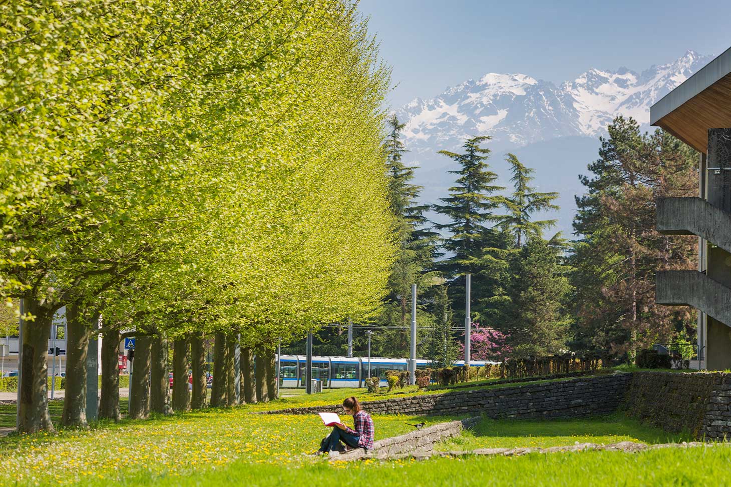 A student relaxes between classes on the lawns of the Saint-Martin-d'Hères campus